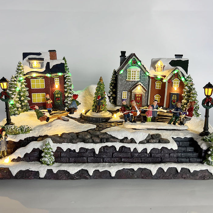 Christmas resin craft ornaments Christmas village scene with LED lights, kids moving tug-of-war, kids playing seesaw, kids christmas tree spinning function
