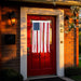 Red door with American flag decoration on a brick wall background
