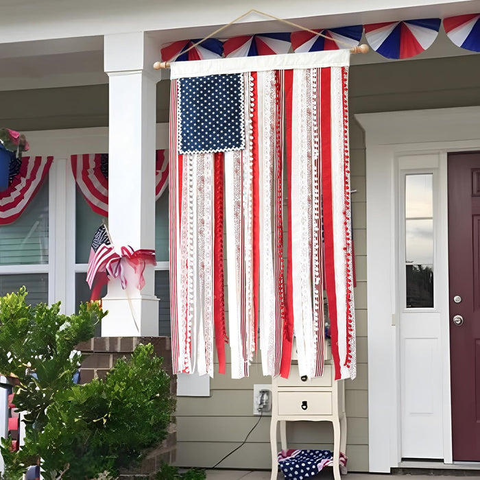 Decorative American flag with ribbons hanging outside a house