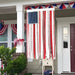 Decorative American flag with ribbons hanging outside a house